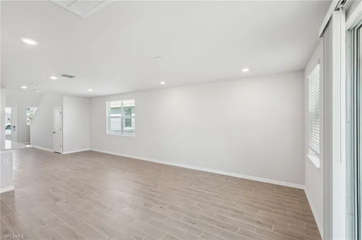 Spare room with recessed lighting, light wood finished floors, visible vents, and baseboards