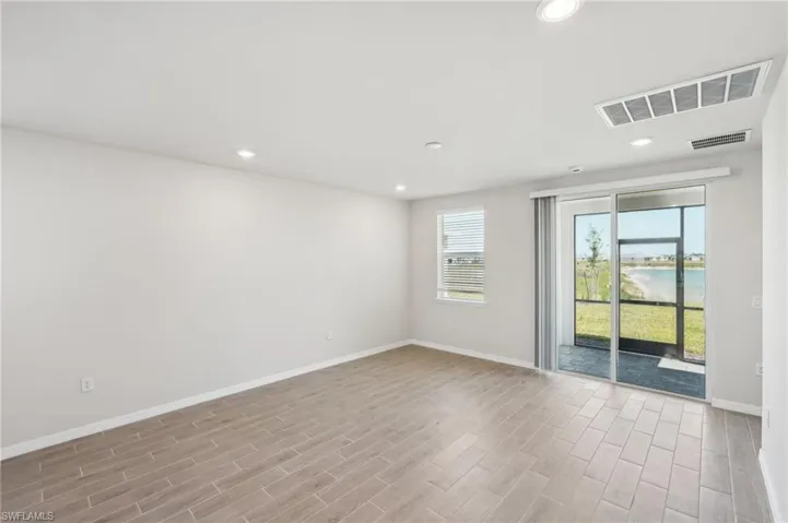 Empty room featuring recessed lighting, visible vents, baseboards, and light wood-style flooring