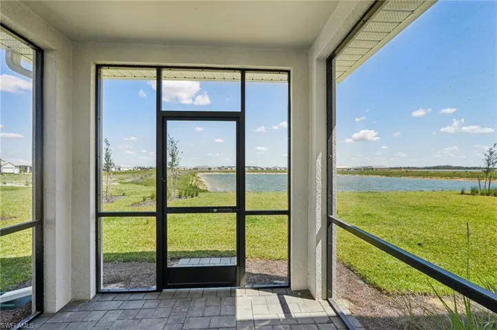 Unfurnished sunroom with a water view