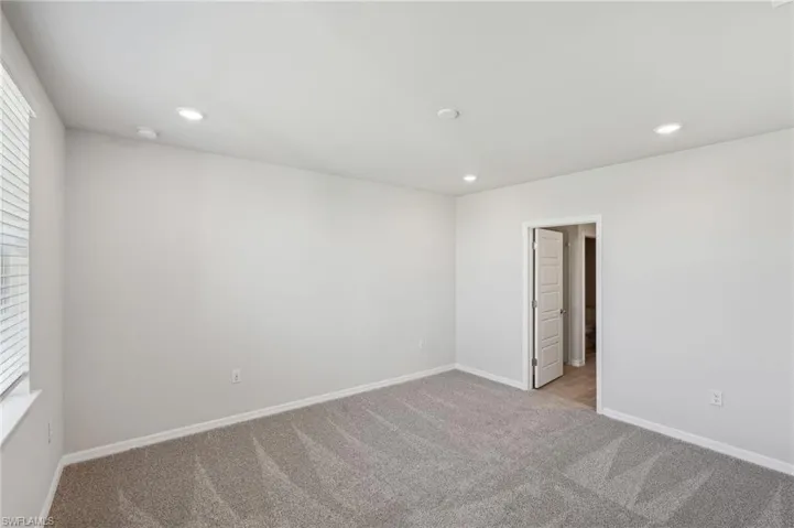 Unfurnished room with baseboards, recessed lighting, and light carpet