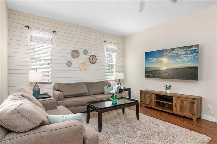 Family room with custom shiplap wall, sliders to lanai and open to the kitchen