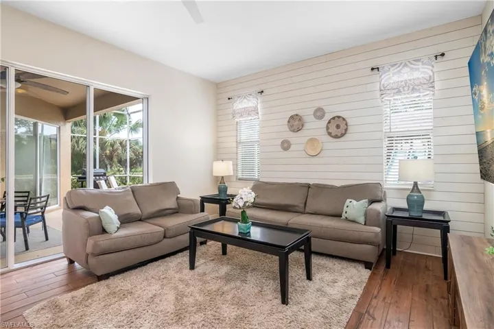 Family room with custom shiplap wall, sliders to lanai and open to the kitchen