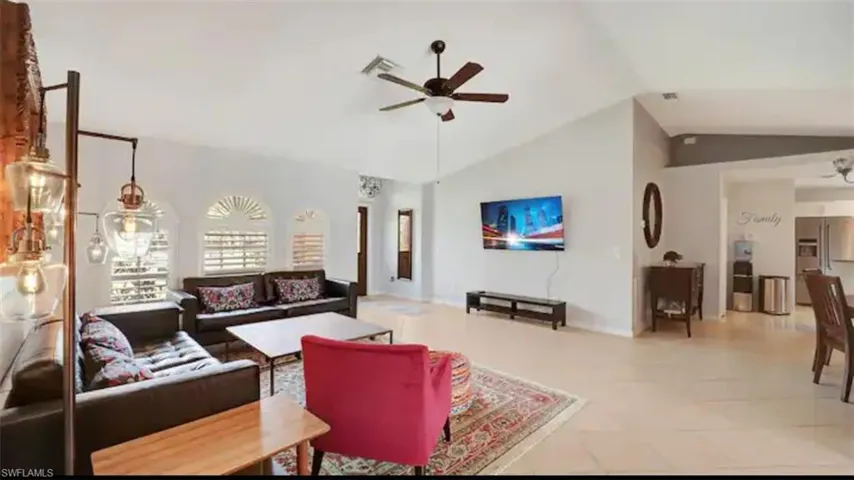 Living room with ceiling fan and vaulted ceiling