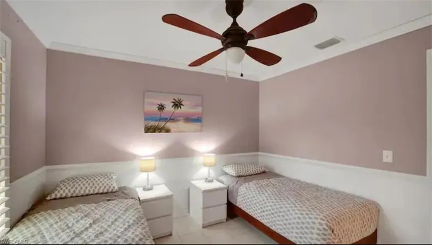 Bedroom with ceiling fan and crown molding