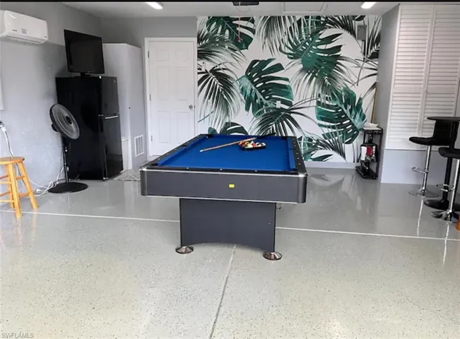 Playroom featuring billiards and a wall mounted air conditioner