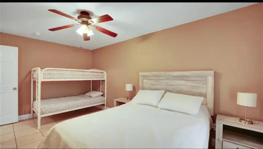 Tiled bedroom with ceiling fan