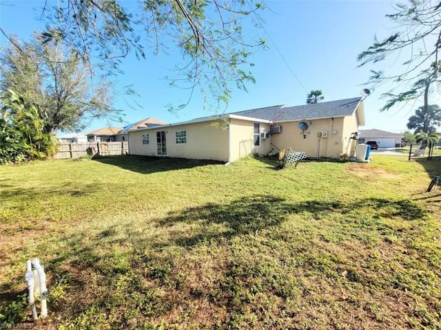 Rear view of house with a yard