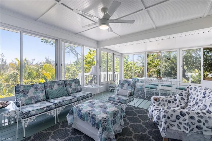 Sunroom / solarium with ceiling fan, an outdoor living space, and a wealth of natural light