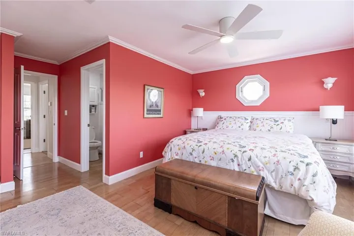 Bedroom featuring crown molding, baseboards, a ceiling fan, and light wood-style flooring