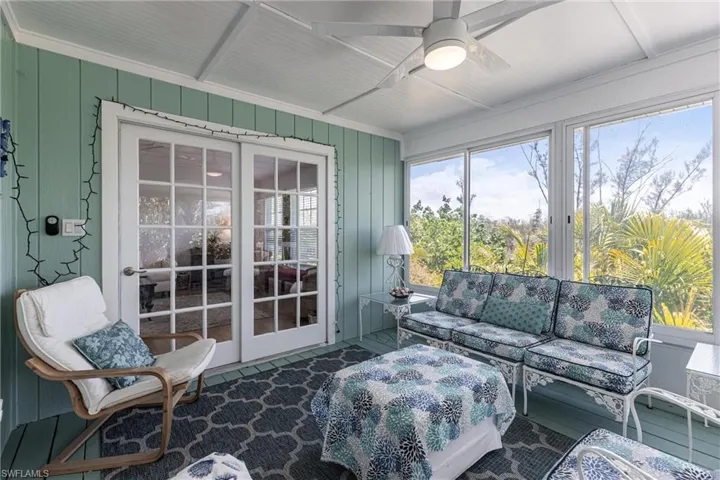 Sunroom featuring a ceiling fan and an outdoor living space