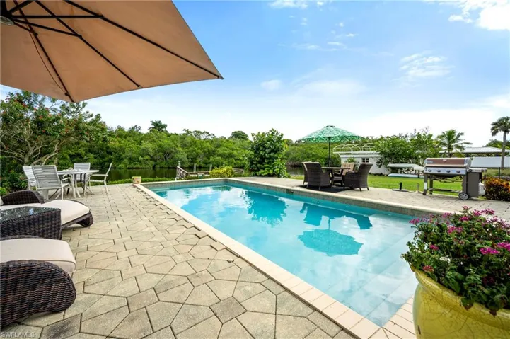 Swimming pool featuring outdoor dining space, a patio area, and grilling area