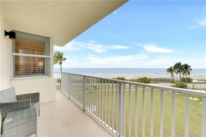 Balcony with view of water and beach