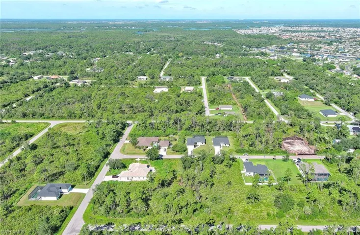 Aerial view of property's location featuring nearby suburban area