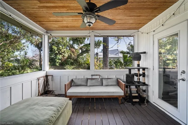 Sunroom featuring ceiling fan and wooden ceiling