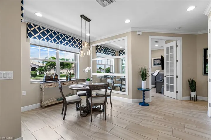 Dining space with ornamental molding and a chandelier