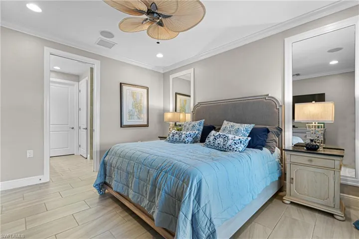 Bedroom featuring ceiling fan and ornamental molding
