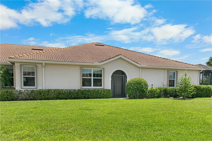 Mediterranean / spanish house with a front yard