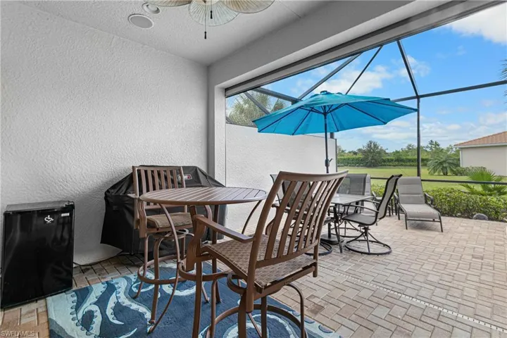 View of patio with ceiling fan and glass enclosure