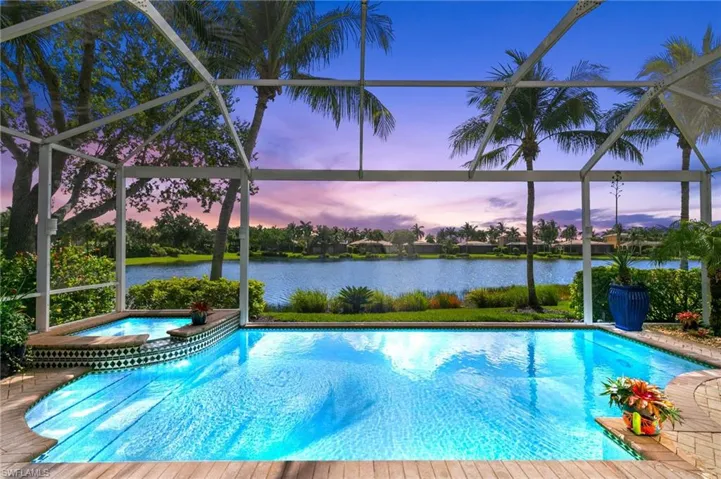 Pool and overflow spa at dusk overlooking lake