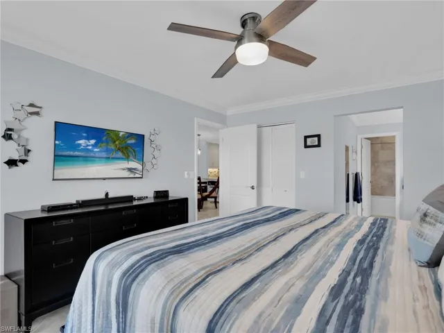 Bedroom with crown molding, a closet, a ceiling fan, and connected bathroom