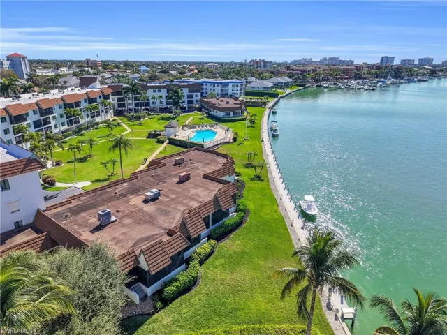 View of urban area with a large body of water and a pool