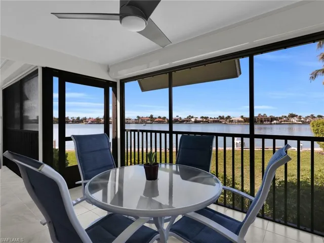 Sunroom / solarium featuring a water view