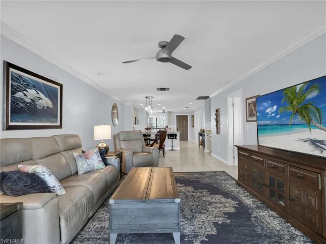 Living area featuring ornamental molding and ceiling fan