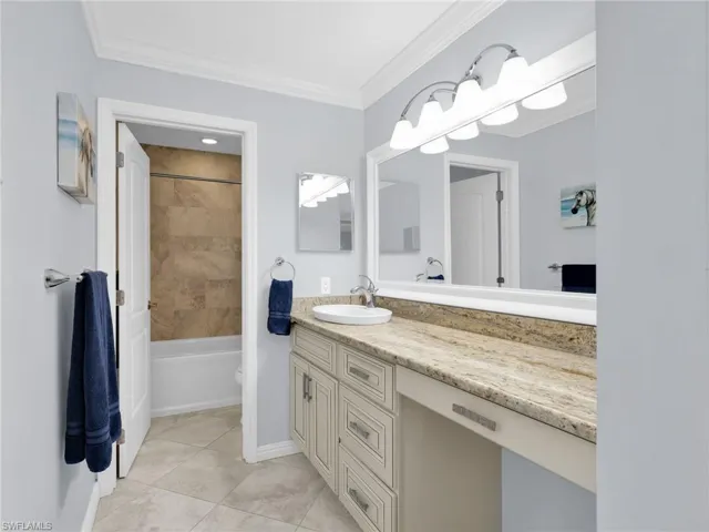 Master Bathroom with vanity, crown molding, bathtub / shower combination, and light tile patterned floors