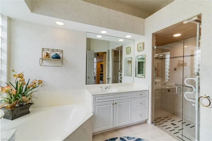 Bathroom featuring independent shower and bath, tile flooring, and vanity