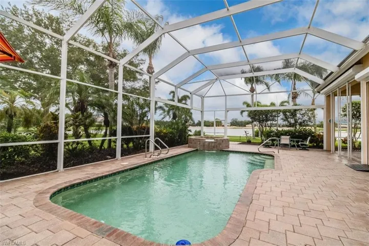 View of pool with a lanai and a patio area