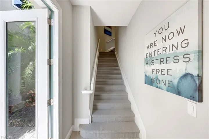 Welcoming entryway with private staircase and elevator access.