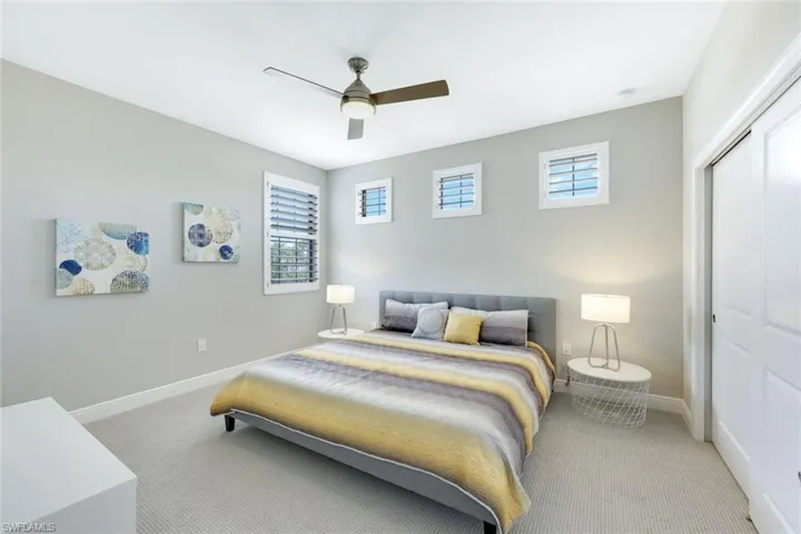 Comfortable guest bedroom with bright natural light and plenty of closet space.