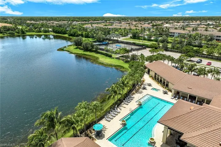 Sparkling pool overlooking the community lake. Notice the lap lanes and the separate spa area.