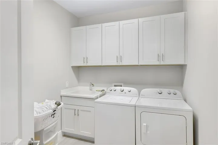 Convenient laundry room with plenty of storage space.