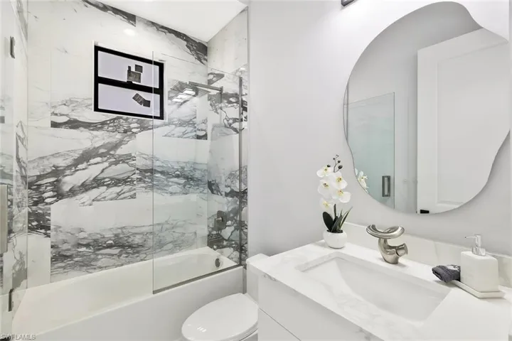 Full bath with vanity and enclosed tub / shower combo