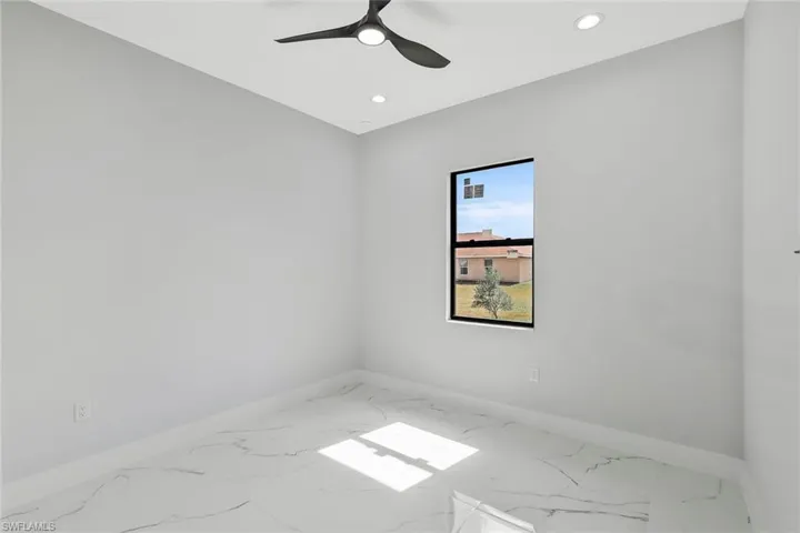 Empty room with recessed lighting, marble look tile flooring, and a ceiling fan