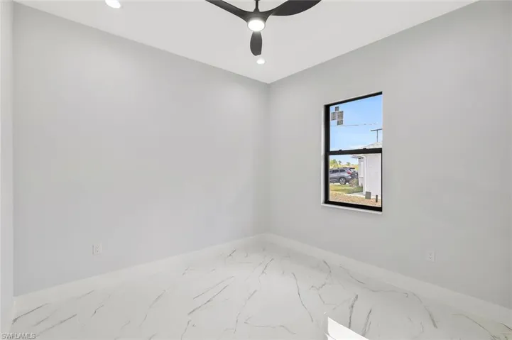 Spare room featuring recessed lighting, marble finish floors, and ceiling fan