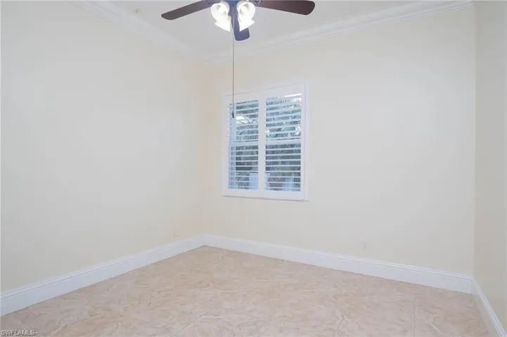 Unfurnished room with ornamental molding and ceiling fan