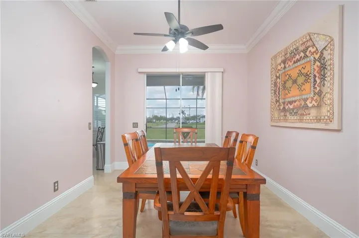 Dining area featuring ceiling fan and ornamental molding