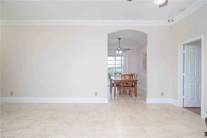 Unfurnished dining area featuring ornamental molding and ceiling fan