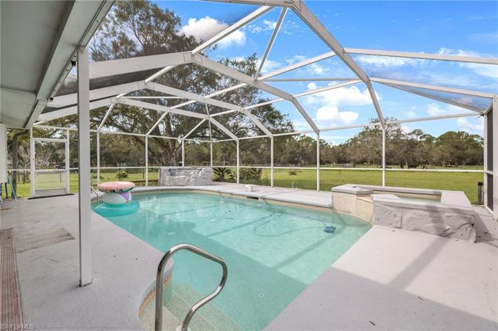 Large pool, hot tub & waterfall feature with a 45' x 13' outdoor exposed patio adjacent