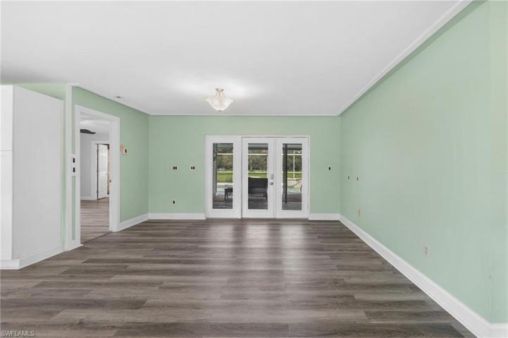 Impact resistant French doors access the impressive outdoor space. Manual accordion shutters protect the windows