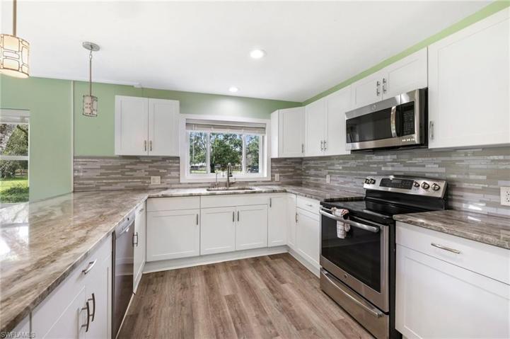 The beautiful glass tile backsplash is big & bold