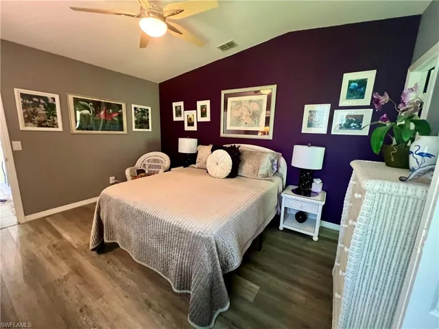 Master Bedroom with ceiling fan, lofted ceiling, and luxury vinyl plank flooring