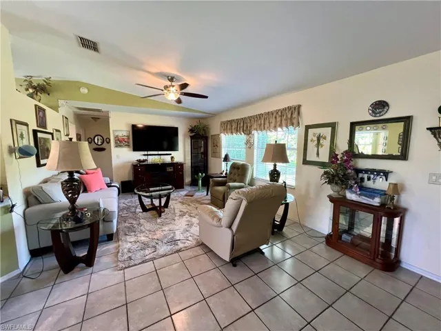 Tiled living room featuring ceiling fan