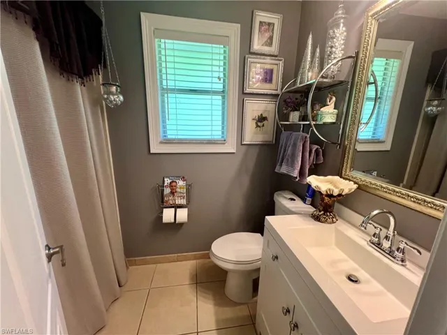Bathroom with tile floors, vanity, and toilet