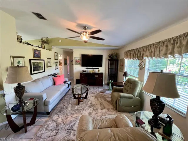 Living room with tile floors and cathedral ceilings