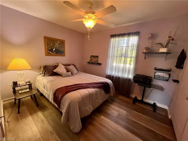Guest Bedroom with luxury vinyl plank  flooring and ceiling fan