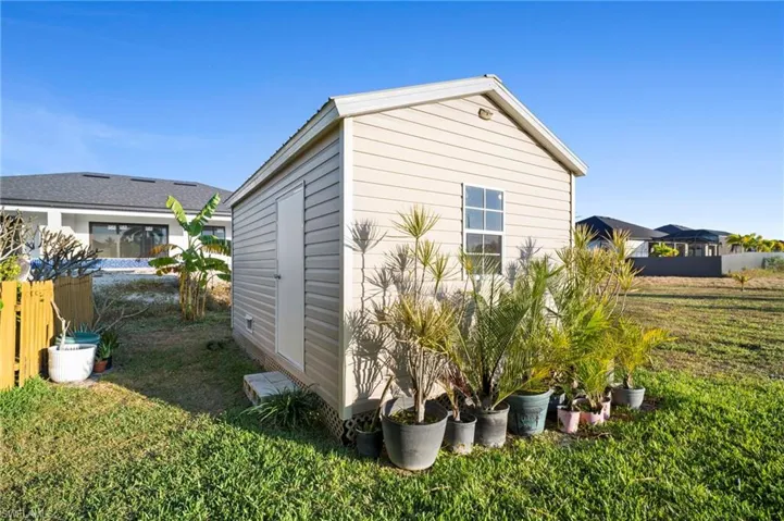 View of side of home with an outdoor structure