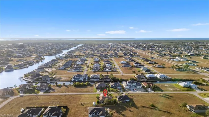 View of property location with nearby suburban area and a large body of water